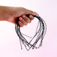 Black metal wavy headband displayed on white background