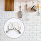Close-up of a sturdy adhesive wall hook applied to a smooth ceramic tile surface.