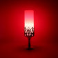 Close-up of LED candle lamp with elegant golden stand and cylindrical candle light