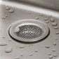 Stainless steel catcher strainer placed in kitchen sink drain opening