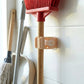 Self-adhesive stick holder clip mounted firmly on wall