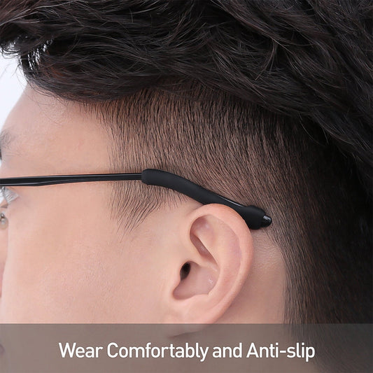 Anti-slip silicone eyeglass ear grips fitted on black-framed glasses, viewed from the side.