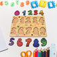 Wooden puzzle board displaying animal-shaped pieces with knobs