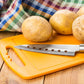 Plastic chopping board positioned on a clean countertop, ready for versatile use.