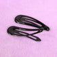 Metal hair clips displayed on white background showing assorted trendy colors