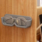 Compact eyewear organizer mounted on wall holding sunglasses