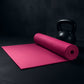 Full view of the non-slip yoga mat laid out on a gym floor.