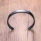 Side view of stylish black-plated stainless steel men's kada bracelet