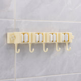 Self-adhesive broom and mop holder rack mounted on wall with utility hooks