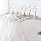 Adjustable arms of the folding clothes hanger demonstrated.