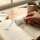 Metal butterfly bookmark lying flat highlighting delicate silhouette