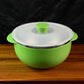 Ergonomic serving bowl with side handles and vented plastic lid