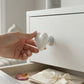 Heart-shaped toilet flush button showcasing stylish bathroom accessory