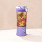 The portable juicer connected to its USB charging cable, highlighting its convenience.