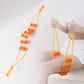 Using the handheld rope massage roller on the shoulder
