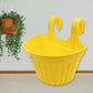 Assortment of colorful hanging plastic planters showcasing design versatility.