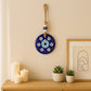 Close-up of blue Evil Eye Wall Hanging charm with beads and natural jute rope