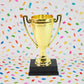 Golden Cheers Birthday Award plastic trophy with printed base label