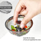 Stainless steel sink strainer in a kitchen basin, preventing food waste.