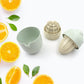 Food-grade plastic juicer ready for making fresh citrus beverages.