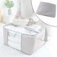 Storage box with window neatly organizing sarees and quilts inside wardrobe