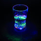 LED Light Glass illuminating a beverage with vibrant colors in a dark setting.