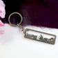 Premium metal keychain showcasing cutwork Gujarati lettering