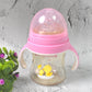 A toddler comfortably holding the Feedora baby feeding bottle with handles.