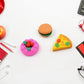 An overhead shot of the food-shaped eraser set, highlighting the variety of designs.