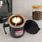 Insulated cat mug showing its dimensions with a measuring tape.