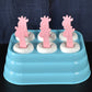 6-cavity giraffe shaped plastic ice cube molds on a white surface