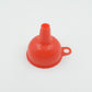 Silicone funnel in action, efficiently pouring oil into a bottle.