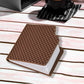 The Chocolate Diary Notebook displayed next to a pen, ready for creative use.