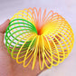 The Rainbow Slinky Toy in its compact, coiled form, displaying its mesmerizing colours.