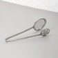 Polished steel serving tong with dual mesh and perforated sides for draining food
