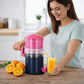 Manual citrus press juicer tool extracting orange juice
