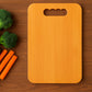 Chopping board made of natural wood with groove for containing juices