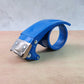 Handheld heavy-duty tape gun with metal rivets and ergonomic handle
