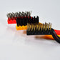 A person using the nylon mini wire brush to clean delicate areas without scratching.