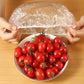 Flexible elastic food cover adapting to a rectangular food container for secure storage.