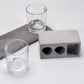 Elegant wine glass holder set with two glasses on a marble base, ideal for home decor.