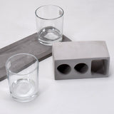 Elegant wine glass holder set with two glasses on a marble base, ideal for home decor.
