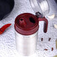 Stainless steel oil container with its small nozzle and lid, ready for use.