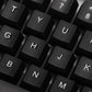 Angled view of the wired keyboard, highlighting its full-size layout and ergonomic key placement.
