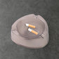 Heat resistant and sturdy plastic ashtray with cigarette grooves