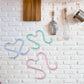 A set of six versatile S hooks metal neatly organising kitchen utensils and towels on a rail.