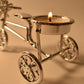 Close-up of tealight candle burning on decorative cycle stand holder