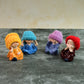 Four resin monk Buddha mini statues arranged side-by-side showcasing traditional poses