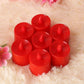 Red LED tea light diya on a dark surface, casting a warm, inviting glow.