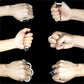 Hand wearing the foldable stress relief ring, demonstrating its compact and discreet design.
